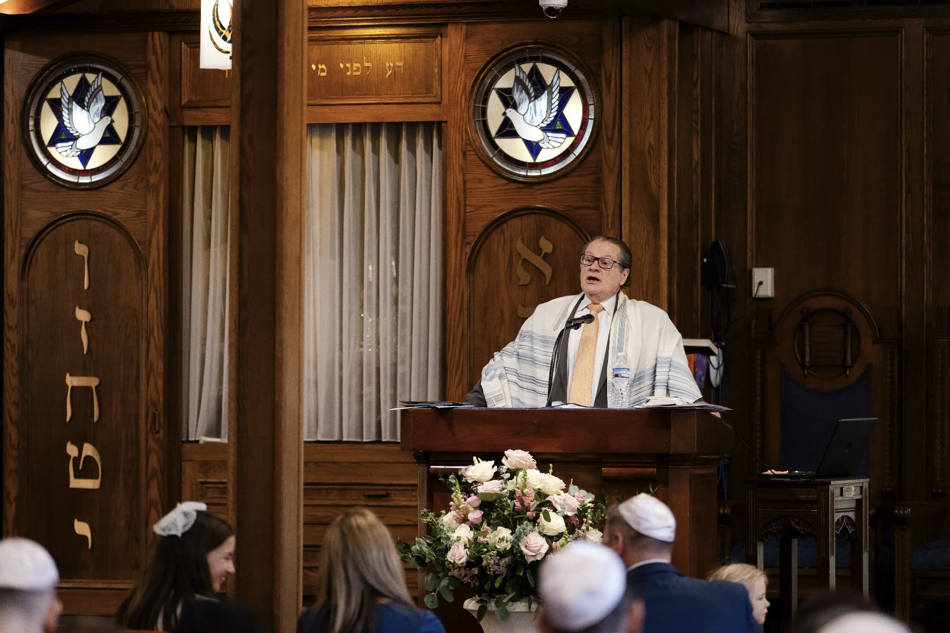 Rabbi leading a service from the bimah in the Adat Shalom sanctuary
